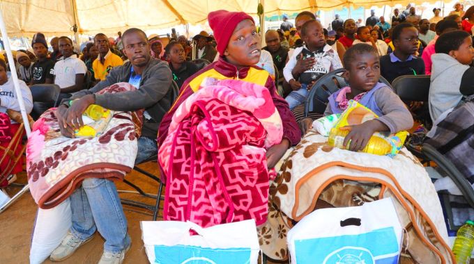 People living with disabilities with blankets and food hampers they received from First Lady Dr Auxillia Mnangagwa in Chakari yesterday