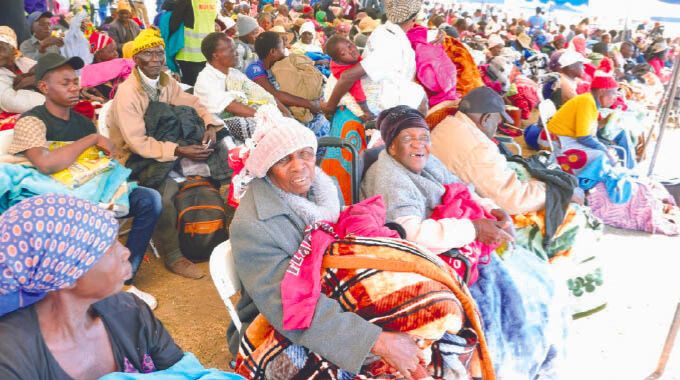 Part of the elderly, people living with disabilities, child-headed families and other vulnerable with blankets and food hampers they received from First Lady Dr Auxillia Mnangagwa in Mashonaland East yesterday