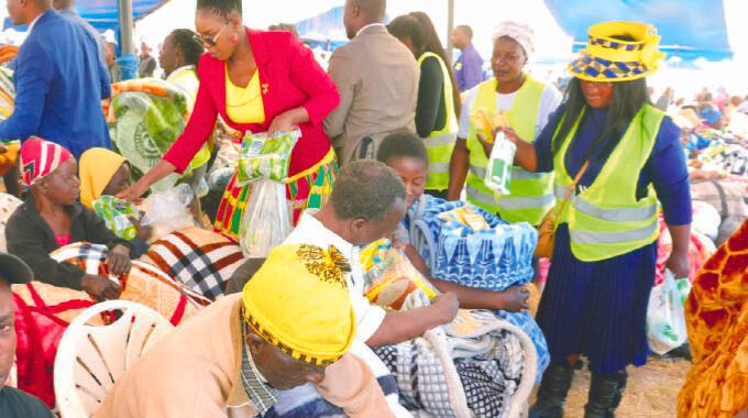 The elderly, people living with disabilities, child-headed families and other vulnerable receiving blankets and food hampers which were donated by First Lady Dr Auxillia Mnangagwa in Mashonaland East yesterday