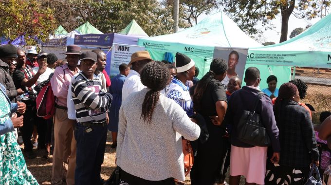 Men and Women queue for medical checks during the City of Harare employee wellness funfair yesterday