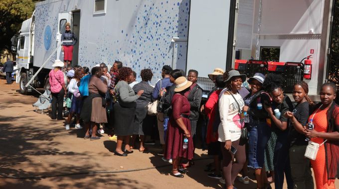 Women queue for breast and other cancers screening in the Angel of Hope Foundation top notch mobile hospital brought by First Lady Dr Auxillia Mnangagwa at the City of Harare employee wellness funfair yesterday