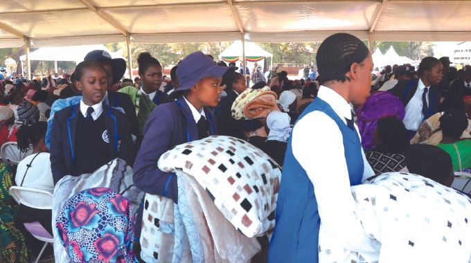 Queen Elizabeth girls high school students distribute blankets and food hampers which were donated by First Lady Dr Auxillia Mnangagwa to the elderly, the disabled, child headed families and other vulnerable groups in Harare