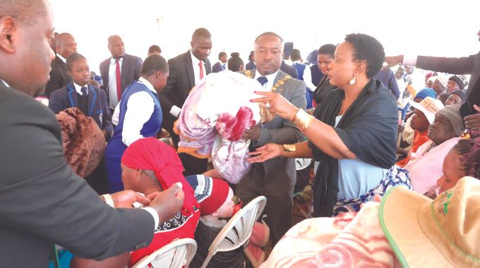 First Lady Dr Auxillia Mnangagwa and Harare Mayor Cllr Jacob Mafume distribute blankets donated by Angel of Hope Foundation to the elderly, the disabled, child headed families and other vulnerable groups in Harare. — Pictures: John Manzongo