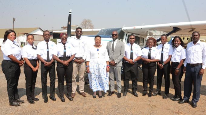 Angel of Hope Foundation patron First Lady Dr Auxillia Mnangagwa interacts with Central Air Transport Services (CATS) general manager Captain Tendai Makaza, while the director and examiner Captain Joe Mparuri, head of training and chief flight instructor Rudo Takudzwa Magwere and flight cadets Ayanda Hela, Dilan Dube, Carla Miga, Emmanuel Thika, Sheryll Gavure and Benjamin Muturuka look on at Charles Prince airport yesterday