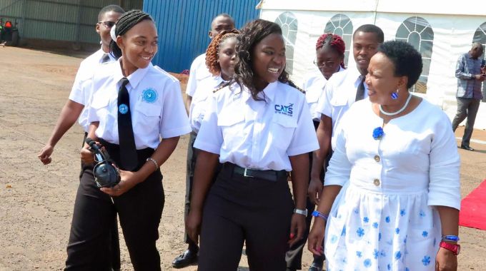 Angel of Hope Foundation patron First Lady Dr Auxillia Mnangagwa interacts with Central Air Transport Services (CATS) head of training and chief flight instructor Rudo Takudzwa Magwere and her students Ayanda Hela, Dilan Dube, Carla Miga, Emmanuel Thika, Sheryll Gavure and Benjamin Muturuka who are being sponsored by Angel of Hope Foundation in their training. – Pictures: John Manzongo