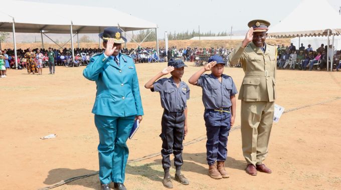 Zimbabwe Republic Police Commissioner Grace Ndou and Chief Superintendent James Sabau and schoolchildren Anotidaishe Tariro and Anesu Maifiri who aspire to become police officers salute during a career guidance, etiquette and stay in school campaign by First Lady Dr Auxillia Mnangagwa in Mashonaland Central. – Pictures: John Manzongo.