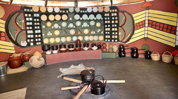 The traditional and modern kitchen utensils such as clay pots and wooden plates and interior design in a Matabeleland kitchen at the Heritage village in Harare