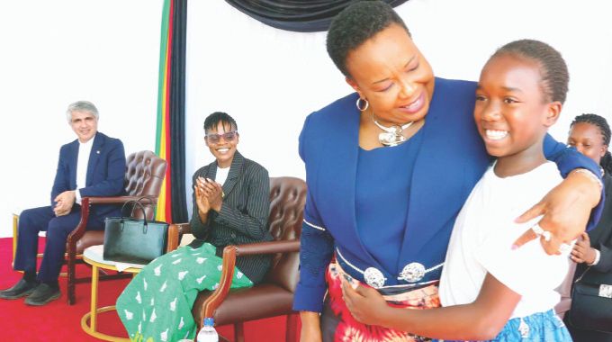 First Lady Dr Auxillia Mnangagwa hugs Tyra Mbofana after she delivered a vote of thanks after a maiden nhanga/gota/ixhiba programne at the Heritage Village. Tyra is also a beneficiary of the girls camp which was hosted by Amai Mnangagwa in April this year