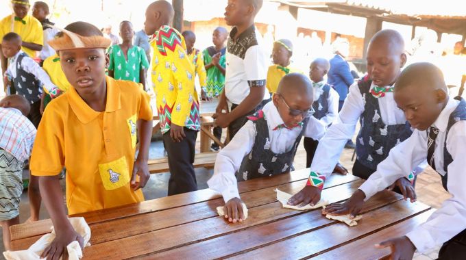 Boys drawn from the country’s provinces clean tables after breakfast at the First Lady’s inaugural national boys camp in Mashonaland West yesterday