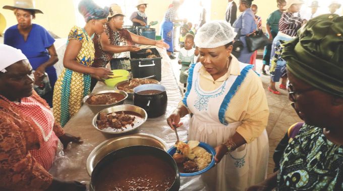 Health Ambassador First Lady Dr Auxillia Mnangagwa serves food which she cooked for learners during her school feeding programme in Mashonaland East yesterday