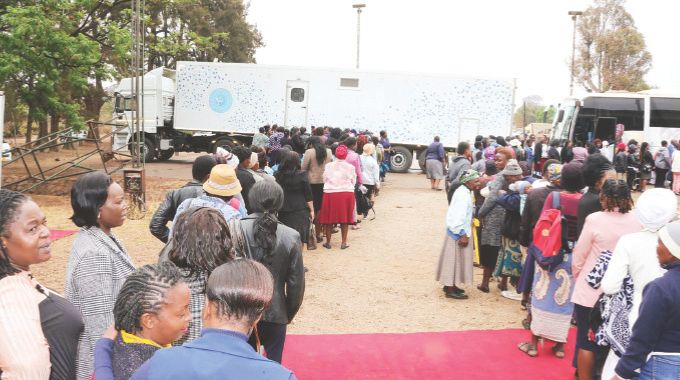 Women working in various Government departments and others queue for cervical and breast cancer screening from Angel of Hope Foundation ultra modern mobile hospital and mobile clinic in Harare