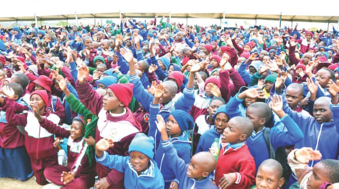 Schoolchildren raise their hands to respond during an interactive session with First Lady Dr Auxillia Mnangagwa in Midlands