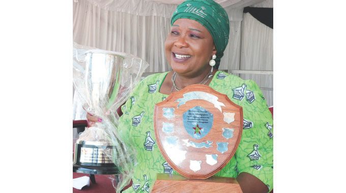 Agric4SHE patron First Lady Dr Auxillia Mnangagwa displays the award and trophy she received in recognition of her outstanding efforts in championing sustainable agriculture and environmental management during the launch of Pfumvudza4SHE in Mashonaland Central yesterday