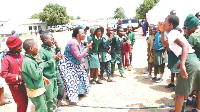 First Lady Dr Auxillia Mnangagwa joins learners in jokingly jeering the losing team after a tug of war competition in Masvingo yesterday. – Pictures: John Manzongo