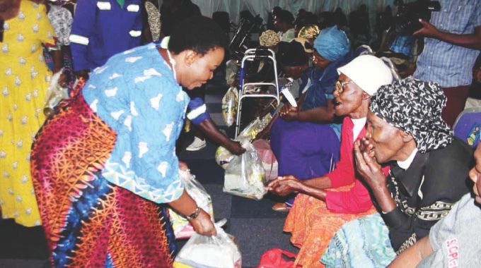 First Lady Dr Auxillia Mnangagwa hands over food hampers to the elderly drawn from Bulawayo, Matabeleland North and South during the Afrikana Family Humanism programme on Saturday