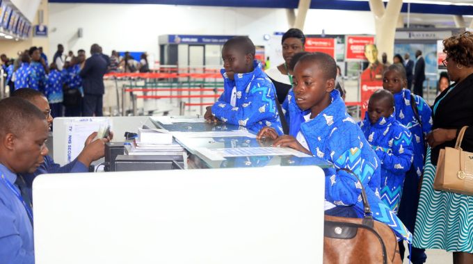 Children’s documents being checked at Robert Gabriel Mugabe International Airport just before their departure