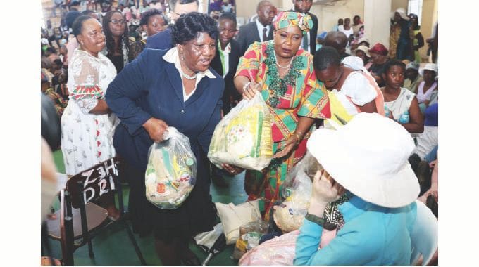 Angel of Hope Foundation patron First Lady Dr Auxillia Mnangagwa distributes hampers in Chitungwiza yesterday. – Pictures: John Manzongo