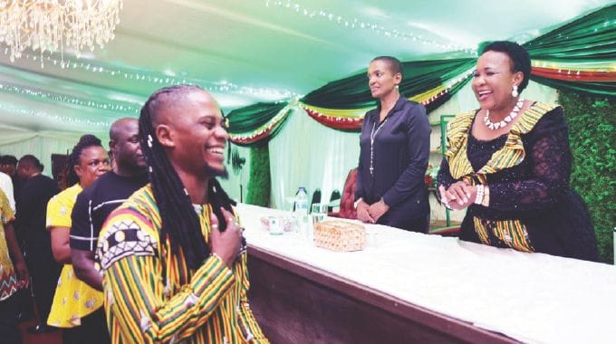 Andy Muridzo shares a lighter moment with First Lady Dr Auxillia Mnangagwa, while Tourism and Hospitality Industry Minister Barbara Rwodzi looks on after he performed at the cultural gastronomic dinner to appreciate Angel of Hope Foundation partners at State House