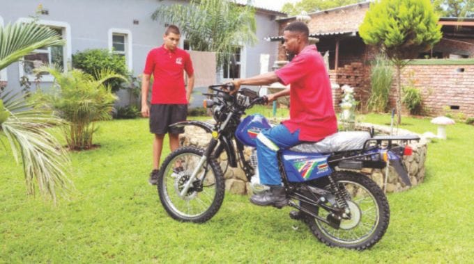 Mario Pereira (left), son to Gellos Motorcycles owner Mr Angello Pereira looks on as his colleague tests the motorbike gifted to Angel of Hope Foundation patron, First Lady Dr Auxillia Mnangagwa to assist in her philanthropic initiative across all communities.