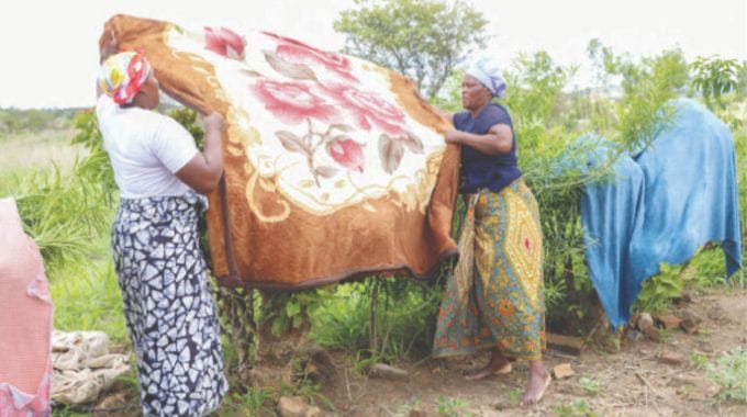 Masiiwa Village community members doing laundry at Gogo Erenesi Chikapinda (72 years) homestead as part of First Lady Dr Auxillia Mnangagwa’s initiatives of assisting the elderly and vulnerable groups in communities Mashonaland Central.