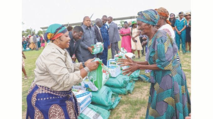 Agric4SHE patron, First Lady Dr Auxillia Mnangagwa, hands over maize seed to Gogo Felita Ngadze (102 years) of Masiiwa Village as part of her philanthropic initiatives to help the elderly and vulnerable groups in communities. – Pictures: Edward Zvemisha.