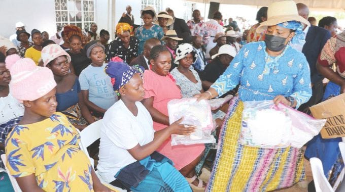 Angel of Hope Foundation patron First Lady Dr Auxillia Mnangagwa hands over new born baby preparation kits to expecting mothers in Gokwe yesterday