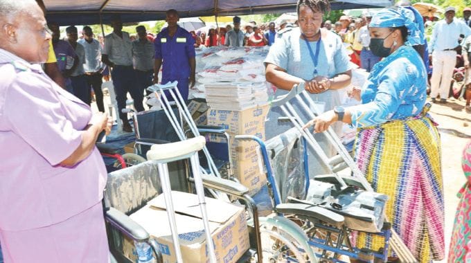 Angel of Hope Foundation patron First Lady Dr Auxillia Mnangagwa hands over wheelchairs, crutches, sanitary pads and other medical equipment to medical staff for use in hospitals in Gokwe yesterday