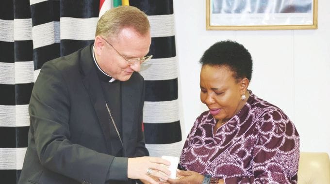 First Lady Dr Auxillia Mnangagwa exchange gifts with Vatican Ambassador Archbishop Janusz Urbanczyk, the Apostolic Nuncio to Zimbabwe at Zimbabwe House on Tuesday. — Pictures: John Manzongo