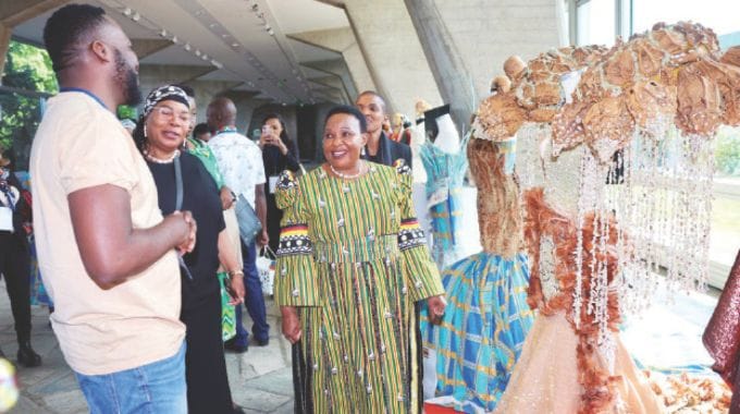Cultural and Heritage patron First Lady Dr Auxillia Mnangagwa, Mrs Kezina Sibanda and Tourism and Hospitality Industry Minister Barbara Rwodzi listen as Mr Jasper Mandizera of Ivhu Tribe explains the Zimbabwean costumes namely: Marina of the soil, the Zimbabwean seed and the Zimbabwean Elegance being exhibited at the Africa week at UNESCO Headquarters in Paris, France yesterday. – Pictures: John Manzongo