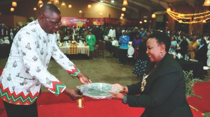 Sport, Recreation, Arts and Culture Minister Lt Gen (Rtd) Ambassador Anselem Nhamo Sanyatwe hands over the Cultural Ambassadorial award to First Lady Dr Auxillia Mnangagwa during the conferment of Ambassadorial role at the Heritage Museum in Harare on Thursday night