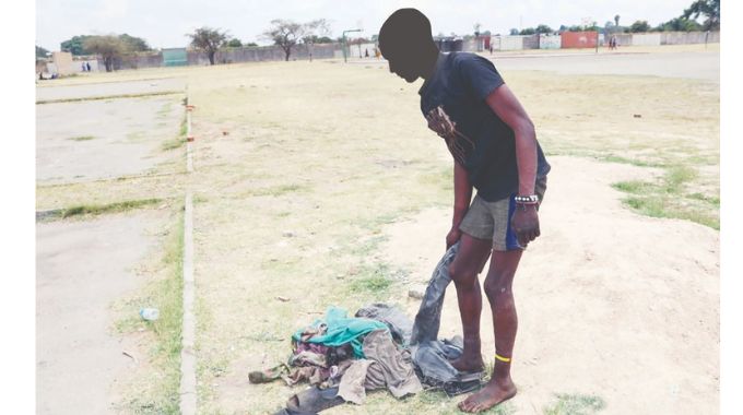 A patient, who arrived wearing 10 layers of clothing, undresses before admission at the Angel of Hope Foundation Drug Rehabilitation Centre during the fourth intake in Mbare.