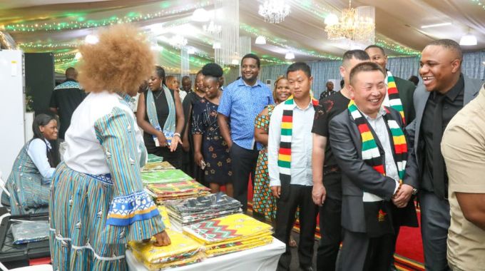 Some of the international delegates admire the national fabric, which took centre stage during the Cultural Gastronomic Dinner at State House in Harare on Friday.