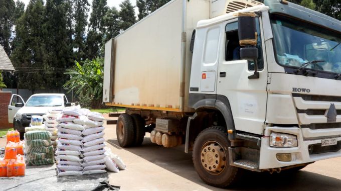 A truck prepares to load some of the distributed goods, including mealie-meal, rice, wheat flour, beverages, and other essentials