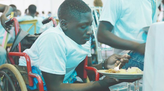 Brilliant Mpofu from Master Seed Home enjoys his food during a party that was hosted by the First Lady Dr Auxillia Mnangagwa for orphaned and vulnerable children from across the country at the ZITF in Bulawayo