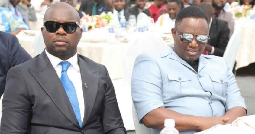 Youth Empowerment, Development and Vocational Training Minister Tino Machakaire (left) and Home Affairs and Cultural Heritage Minister Kazembe Kazembe who were the highest bidders for the book follow proceedings at Baradzanwa Cultural Village in Mazowe