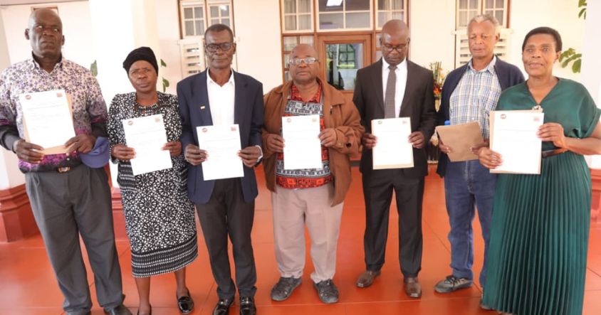 Descendants and relatives of the revered Chinhoyi Seven Heroes display residential stand offer letters at Zimbabwe House
