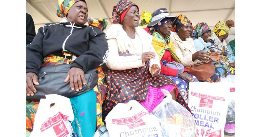 Smiles light up the faces of elderly women beneficiaries as they proudly don their new doeks and wrappers while displaying food hampers received through the First Lady’s Doek Drive initiative at Uswaushava Primary School in Chiredzi.