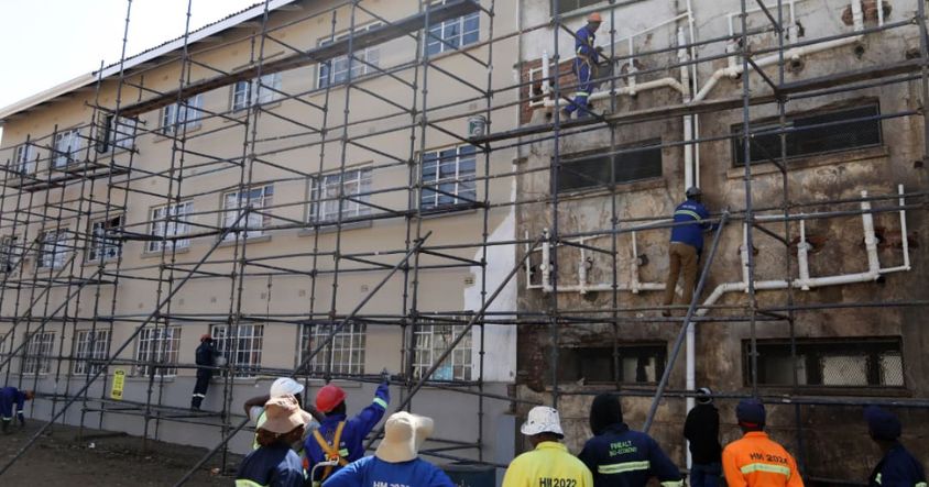 ED AID1 workers undertake rehabilitation works at Matapi Flats in Mbare, Harare, yesterday as efforts to restore the residential complex continue.