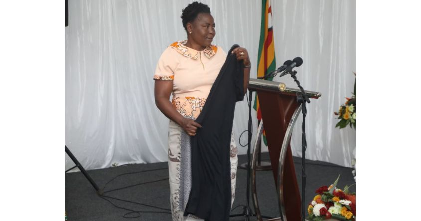 Mrs Charity Mangena proudly displays the skirt she converted into a doek during First Lady’s interactive session on the Doek Drive Initiative at Zimbabwe House.