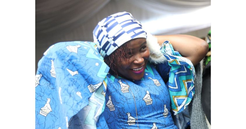 Joy is written all over the face of Mrs Langutane Chiota as she ties her doek during First Lady’s Doek Drive Initiative with churches at Zimbabwe House.