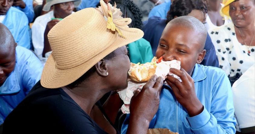 Mother and child enjoy food together at the A mother hugs her child at the Angel of Hope Rehabilitation Centre